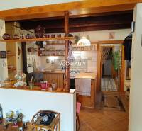 A kitchen in a cabin with wooden paneling, a traditional touch, and ceramic accessories.