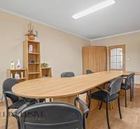 Meeting room: wooden table, chairs, cabinets, and shelves in the office.