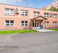 A single-story office building on Jilemnického Street in Dunajská Streda with parking spaces.