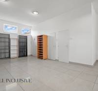 Commercial premises with shelves and light tiles, suitable for office use.