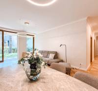 A stylish living area with a sofa and a vase with flowers in a 4-room apartment.