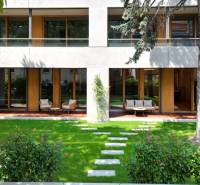 Garden terrace of a 4-room apartment with loungers and lawn on Bradlianska in Bratislava.
