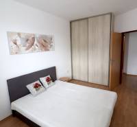 Bedroom in a 2-room apartment with a bed and a built-in wardrobe.