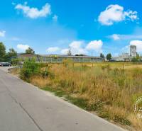 Lands - commercial in Piešťany on Priemyselná Street with buildings and parking lot.