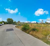 Road with cars and land for sale on Priemyselná Street in Piešťany.