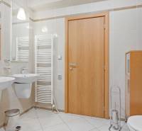 A bathroom with two sinks, mirrors, a toilet, and a built-in wardrobe in a 4-room apartment.