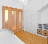 A bright room in a 4-room apartment with wooden flooring and storage space.