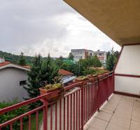 A balcony in a 4-room apartment on Guothova Street in Bratislava with a view of greenery.