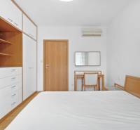 A bedroom with built-in wardrobes and a desk in a 4-room apartment.