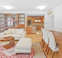 Living room connected to the kitchen in a 4-room apartment with wooden furniture and comfortable seating.