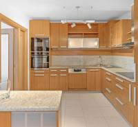 Kitchen in a 4-room apartment with a wooden kitchen unit and appliances.