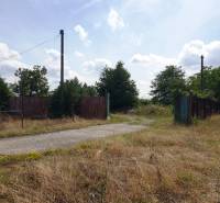 Land - commercial in Trenčianske Bohuslavice with old fences and a broken road.