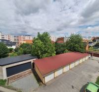 A view of the garages and greenery between the buildings at Pavlovič Square in Prešov.