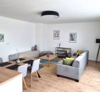 Living room in a 3-room apartment with a dining table, sofa, and decorations.