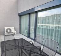 A balcony in a 3-room apartment with metal furniture and air conditioning.