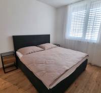 Bedroom with a double bed and nightstands in a 3-room apartment.