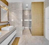 A luxurious bathroom with a double sink and gold details in a 4-room apartment.
