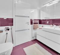 A bathroom in a 4-room apartment with purple tiles and modern equipment.