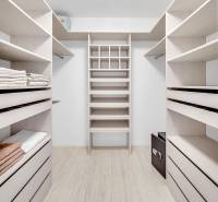 A wardrobe with light shelves and storage space in a 4-room apartment.