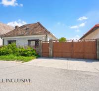 A family house in Jahodná with a brown gate and a garden in front of the entrance.