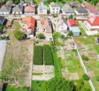 Aerial view of family houses in Jahodná with gardens and small fields.