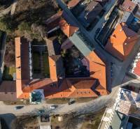 An aerial view of the buildings on Banícke Square in Gelnica. Hotels and guesthouses.