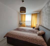 A bedroom with patterned wallpaper and curtains in a 3-room apartment.
