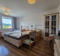Bedroom with a wardrobe, crib, and view from a 4-room apartment.