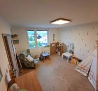 Children's room of a 4-room apartment with a chair, table, and tent.