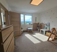 Children's room in a 4-room apartment with carpet flooring and play elements.