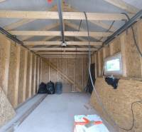 Unfinished room in a family house with wooden construction and OSB boards.