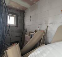 Building materials and electrical installation in a partially completed room of a family house.