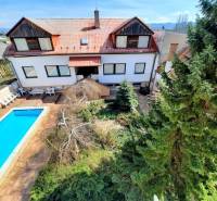 A courtyard with a swimming pool and greenery in Piešťany on Pod Párovcami Street, near a 2-room apartment.