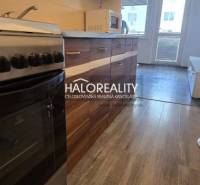 Kitchen unit with a stove in a studio apartment, wooden floor, brightness of the space.