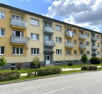 Apartment building on Obrancov Mieru, Púchov with green front gardens and balconies.