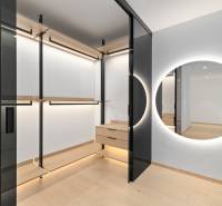 A wardrobe in a 2-room apartment with a mirror and wooden details.