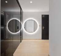 A hallway in a 2-room apartment with a round mirror and a built-in wardrobe.