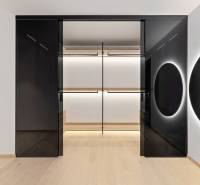 A minimalist wardrobe interior with a mirror and lighting in a 2-room apartment.