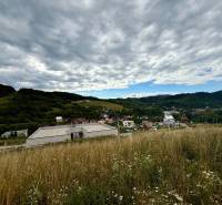 Hilly landscape in Divinka with a view of plots - living under a cloudy sky.