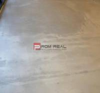 A view of the floor in bright commercial spaces with large windows.