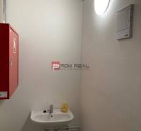 Break with light, sink, and fire extinguisher in commercial premises.