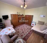 Living room in a 3-room apartment with armchairs, a carpet, and a wardrobe.