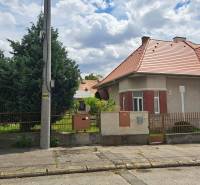 A family house on Nécseyho Street in Nitra with windows and a fence by the road.
