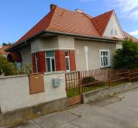 A family house on Nécseyho Street in Nitra with a red roof and brick facade.