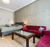 Living room in a two-room apartment with sofas and a decorative wall.