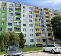 Apartment building on Železiarenská Street in Galanta with parked cars and greenery.