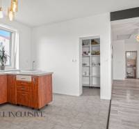 A kitchen in a family house with a wooden cabinet and built-in shelves.