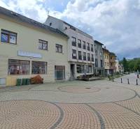 The building on Mostová Street in Ružomberok with a paved square and surrounding infrastructure.