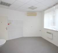 Commercial space with a sink, air conditioning, and a large window, available for rent.