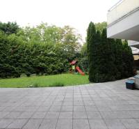 Courtyard with a lawn and a children's playground in the Commercial Spaces on Žatevná in Dúbravka.
